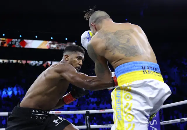 Anthony Joshua punches Oleksandr Usyk