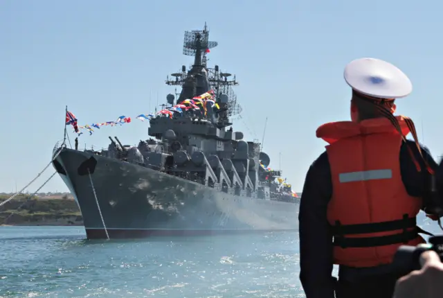 A sailor looks at the Russian missile cruiser Moskva moored in the Ukrainian Black Sea port of Sevastopol, Ukraine 10, 2013.