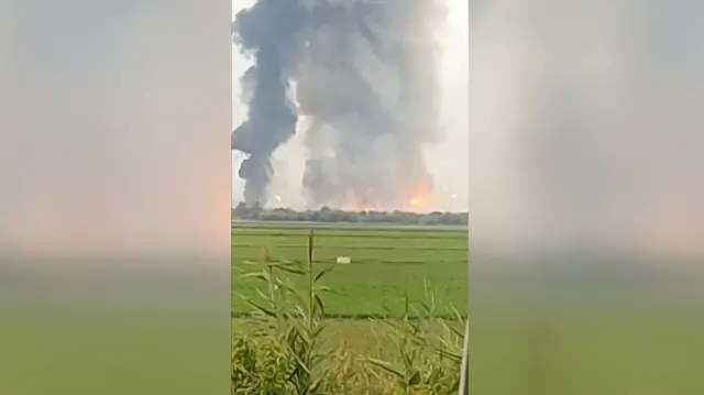 This still frame from a UGC video taken with a smartphone and released on the ESN platform on August 16, 2022 shows fire and smoke billowing from munitions depot in Crimea early on August 16, 2022.