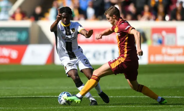 Motherwell's Blair Spittal tackles Livingston's Stephen Omeonga