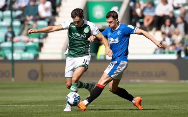 Joe Newell and Ryan Jack tussle for possession