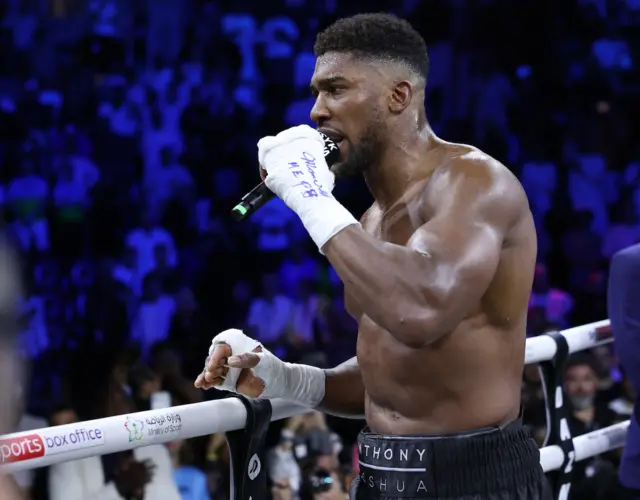 Anthony Joshua speaks on the ringside microphone