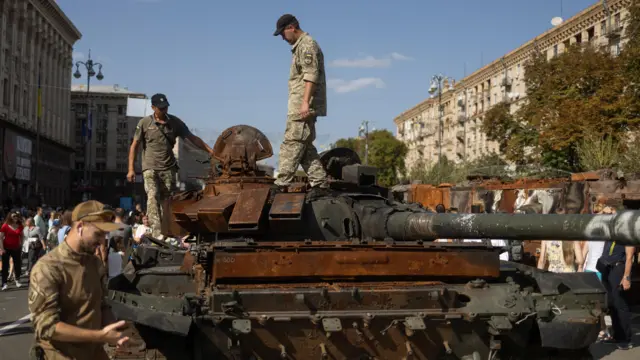 People visit an exhibition of destroyed Russian military vehicles and weapons in Kyiv