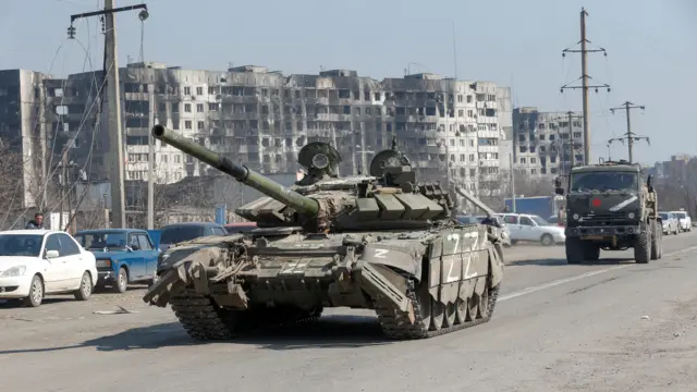 A tank of pro-Russian troops drives in a street in Mariupol