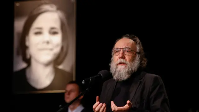 Alexander Dugin delivers a speech during a memorial service for his daughter in Moscow this morning