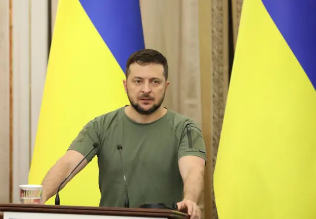 Ukrainian President Volodymyr Zelensky in front of the Ukrainian flag