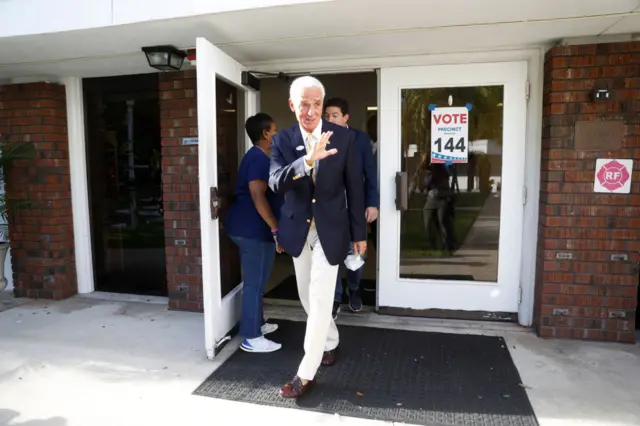 Rep Charlie Crist waves as he leaves a polling station in Florida