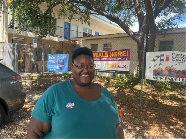 Tamilla Mullings, who is a black woman smiling in a t-shirt, pictured after voting in Miami Gardens