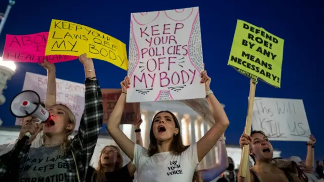 Pro-choice demonstrators, including Emma Harris, left, and Ellie Small, center, both students at George Washington University gather in front of the Supreme Court of the United States on Tuesday, May 3, 2022 in Washington, DC.