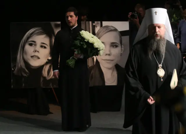 Russian Orthodox priests pray during a memorial ceremony for Daria Dugina, on August 23, 2022 in Moscow