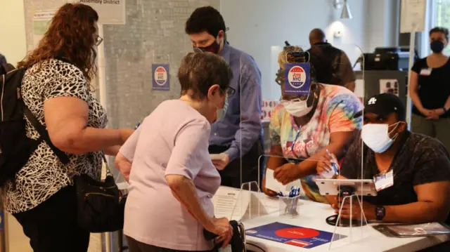 People vote in a polling station in a residential building in New York's 12th Congressional District on August 23, 2022 in New York City.