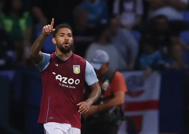 Douglas Luiz celebrates