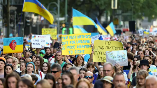 People march during a Freedom Parade in Berlin, Germany