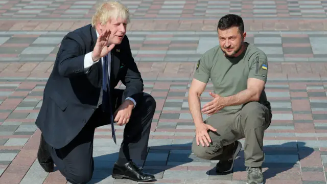 Ukrainian President Volodymyr Zelensky (R) and British Prime Minister Boris Johnson (L) attend the inauguration of a plate with Johnson's name on the 'Walk of the Brave', dedicated to politicians who support Ukraine amid the Russian invasion, in Kyiv, Ukraine