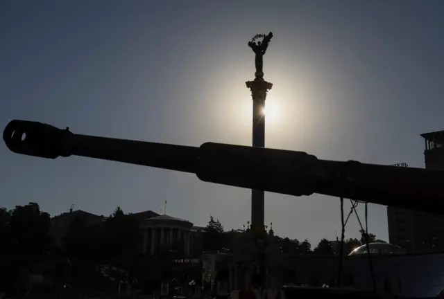 A cannon of a destroyed Russian military vehicle on Kyiv's main street Khreshchatyk is pictured with Independence Monument at the background