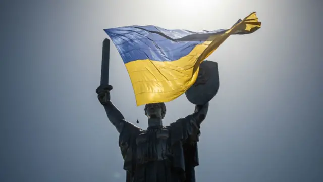 A drone flies a flag over the motherland monument in Kyiv