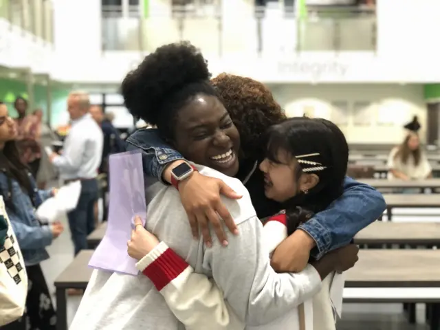 Delighted students hug each other after getting their GCSE results in Wigan