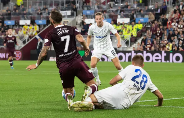 Jorge Grant is shown a second yellow for simulation under a tackle from  Karol Mets during a UEFA Europa League play-off second leg match between Heart of Midlothian and FC Zurich at Tynecastle,