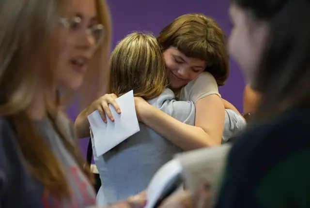 Students in Brighton hug each other on an emotional GCSE results day