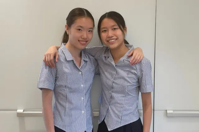 Nicola and Victoria Tsang pose for a photo after receiving identical GCSE results