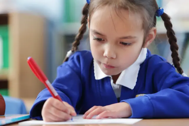 A young girl studying in the classroom