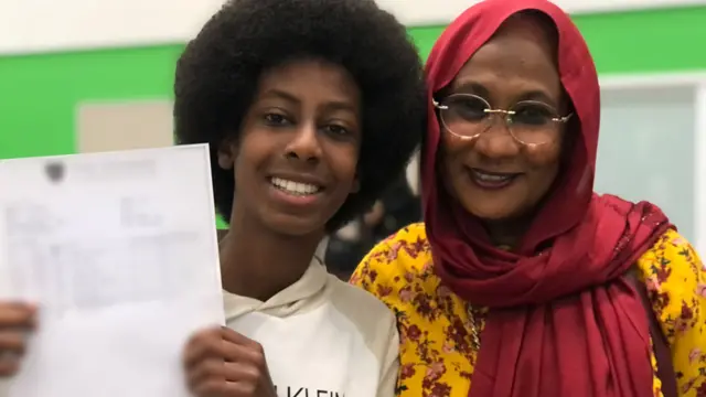 Ibrahim holding his results next to his mum Howayda