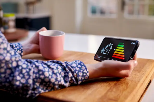 Close-up of a female hand holding an energy smart meter