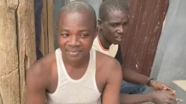 Two men rescued from the collapsed building sitting on a bench