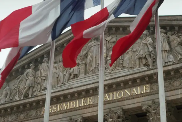 French flags fly in front of the Assemblee Nationale, a legislative building of the French government