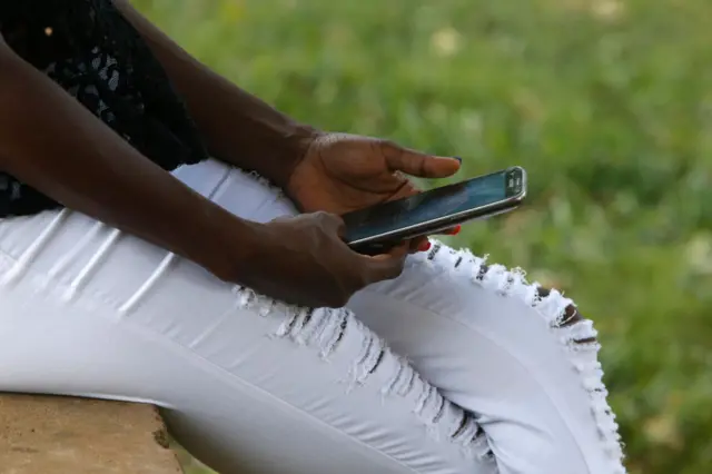 Ugandan woman using a cell phone.