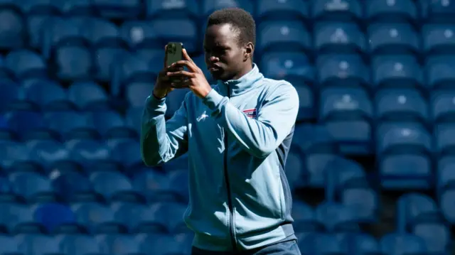 Ross County midfielder Victor Loturi takes a selfie at Ibrox