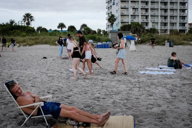 Beachgoers leave after the launch of the Artemis I unmanned lunar rocket was postponed, in Cocoa Beach, Florida