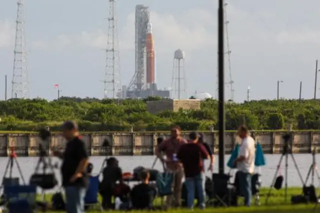 News crews look at the launch pad at the Kennedy Space Center in Florida