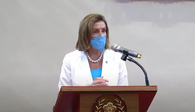 Nancy Pelosi wearing a mask answers questions at a press conference in Taipei