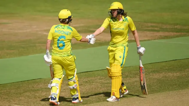 Beth Mooney and Tahlia McGrath celebrate reaching a 100 partnership