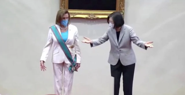 Nancy Pelosi, wearing the sash, and Tsai Ing-wen