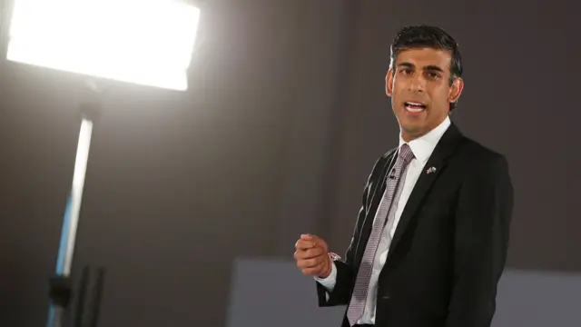 Rishi Sunak speaks on stage