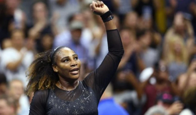 Serena Williams holds her fist up in celebration
