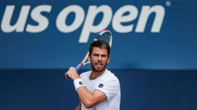 Cameron Norrie in front of the US Open logo