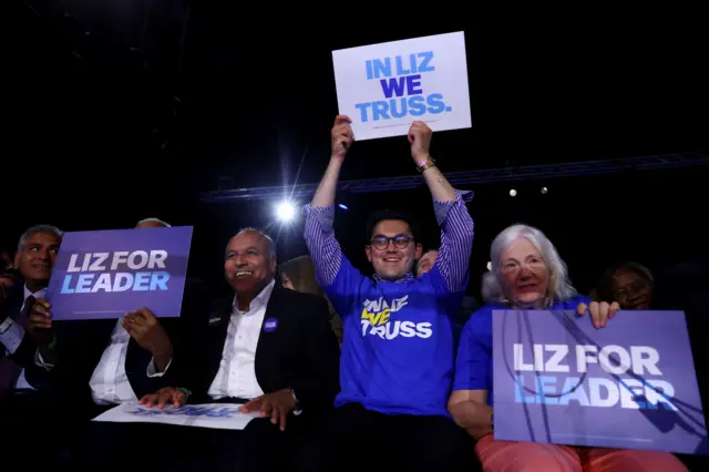 Supporters of Conservative leadership candidate Liz Truss hold placards