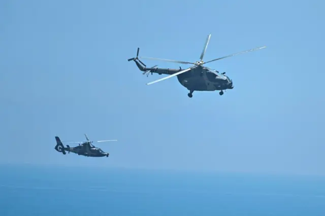 Chinese military helicopters fly past Pingtan island,