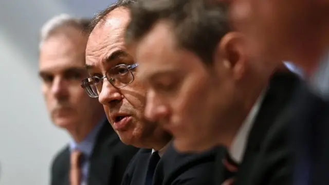 The Bank of England Governor Andrew Bailey (2L) speaks to the media during a press conference at the Bank of England in London, Britain, 04 August 2022