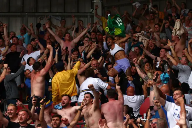 Raphinha celebrates with Leeds fans