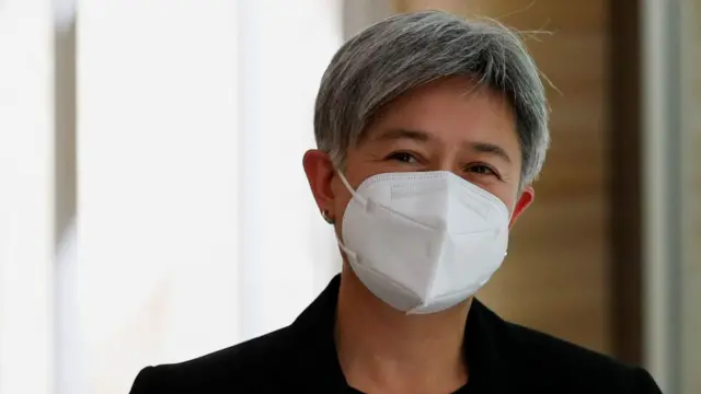 Australian Foreign Minister Penny Wong arrives at the G20 Foreign Ministers' Meeting wearing a face mask