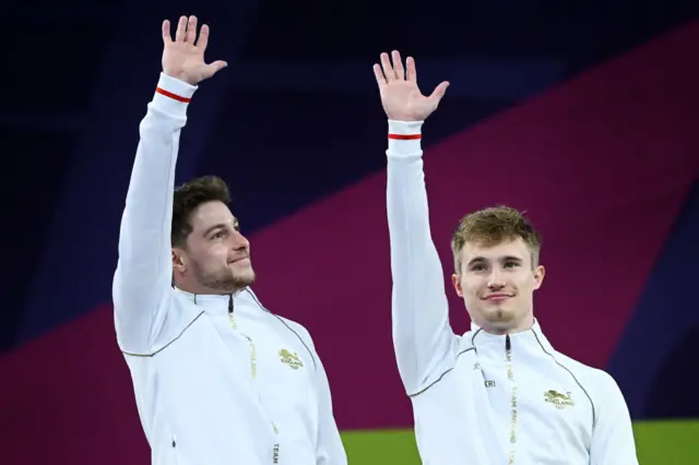 Anthony Harding and Jack Laugher of Team England wave during the medal ceremony for the Men's Synchronised 3m Springboard Final