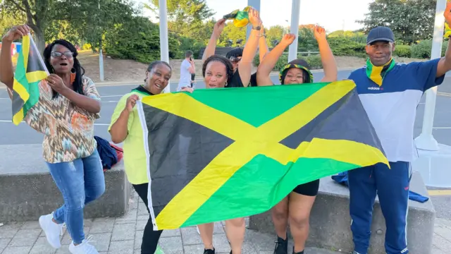 Vanessa and friends with Jamaica flags