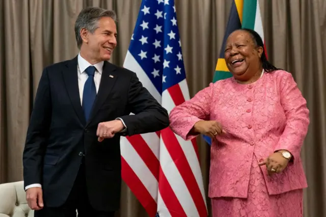 US Secretary of State Antony Blinken (L) is greeted by South Africa's Foreign Minister Naledi Pandor (R) as he arrives for a meeting at the South African Department of International Relations and Cooperation in Pretoria, South Africa, on 8 August.