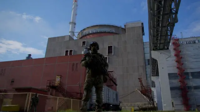 A Russian serviceman stands guard the territory outside the second reactor of the Zaporizhzhia Nuclear Power Station in Energodar on May 1, 2022