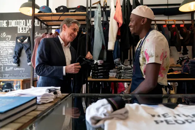 US Secretary of State Antony Blinken (L) speaks with jeans designer Tshepo (R) as he tours the Victoria Yards neighborhood in Johannesburg, on August 7, 2022. -