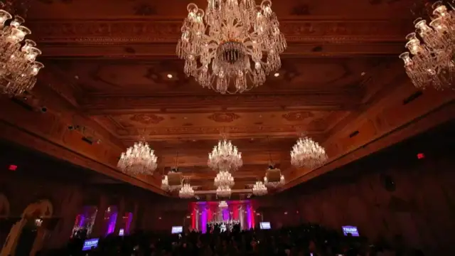 A huge hall for entertaining, the ceiling covered with huge chandeliers